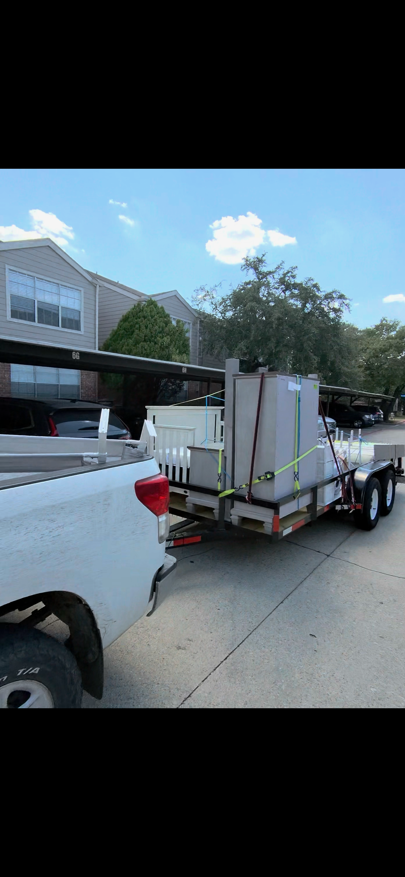 Pickup truck connected to a trailer carrying furniture