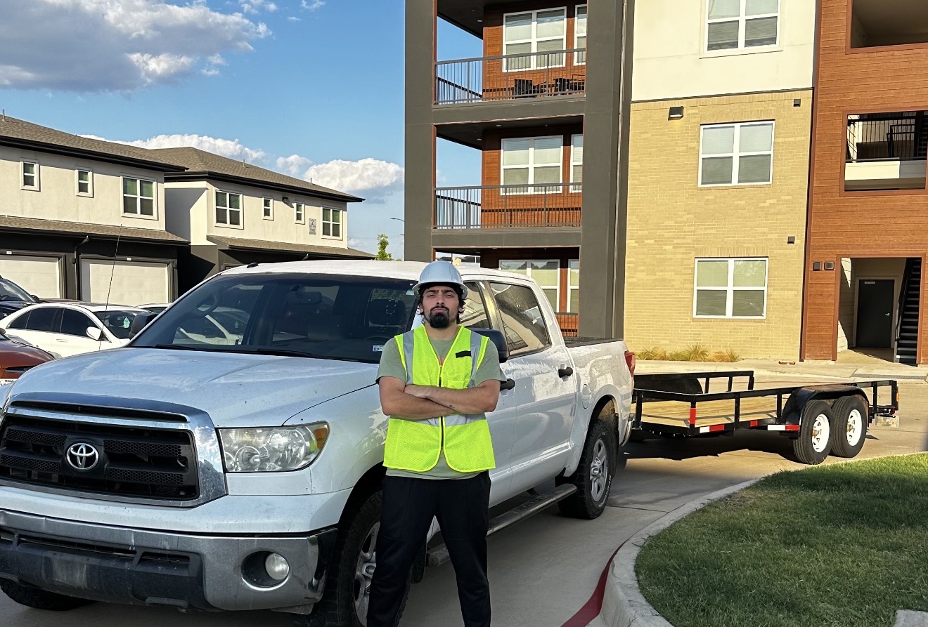 Z&M crew member beside a pickup truck and hauling trailer