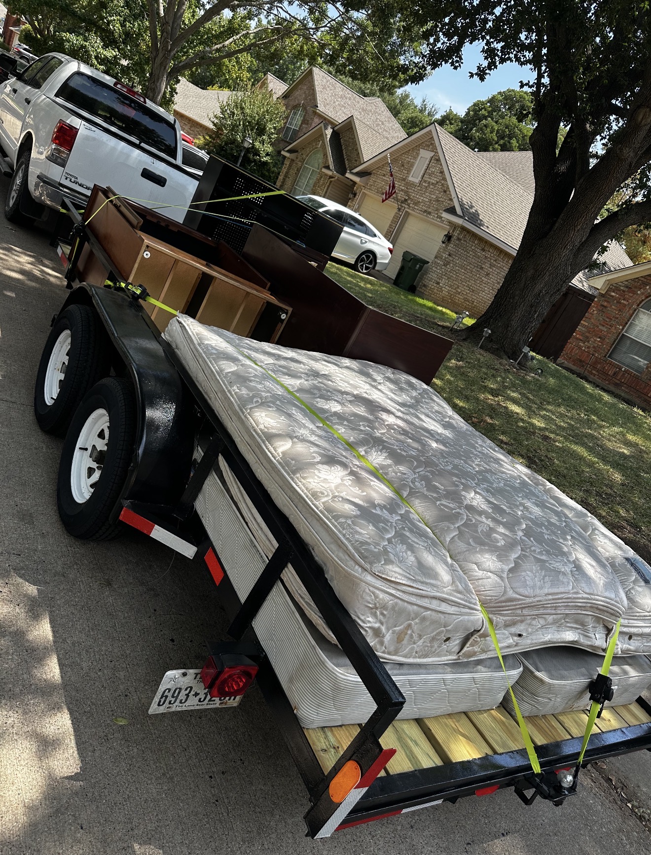 Mattresses and furniture loaded onto a trailer